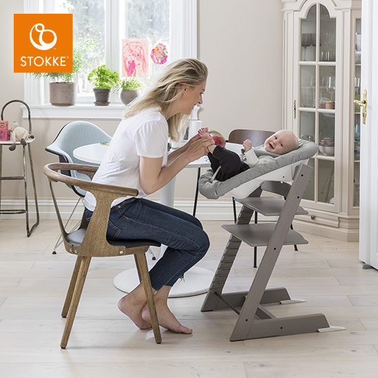 Stokke® Tripp Trapp® mit dem Newborn-Set und Baby am Frühstückstisch mit Vater und zweitem Kind