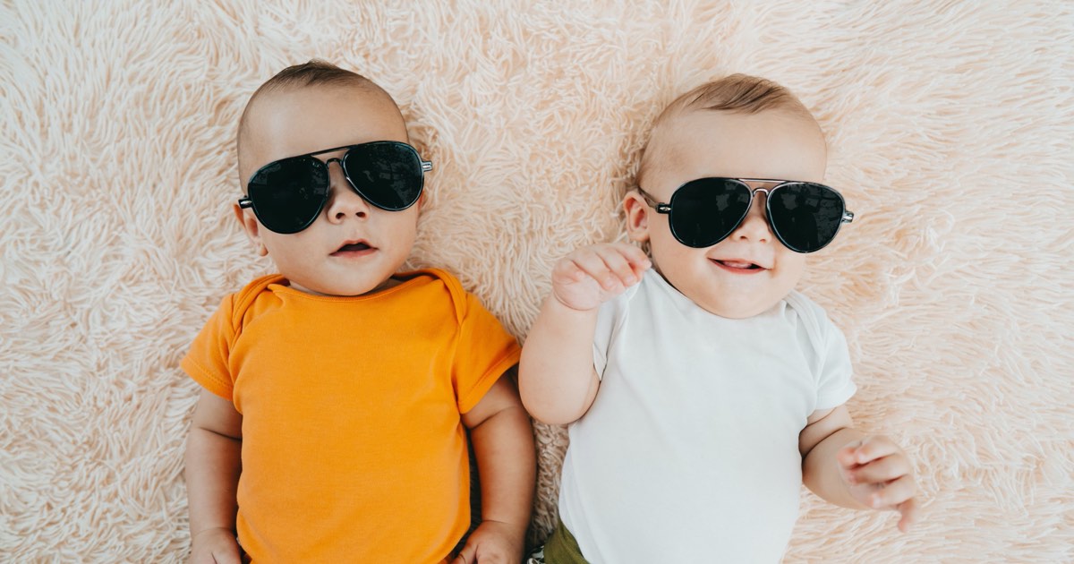 Babys liegen mit coolen Sonnenbrillen im Bett